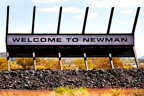 A 'Welcome to Newman' sign on mining equipment installed on the edge of town.