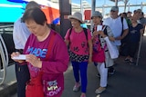 Chinese tourists line up for cruise in Cairns.
