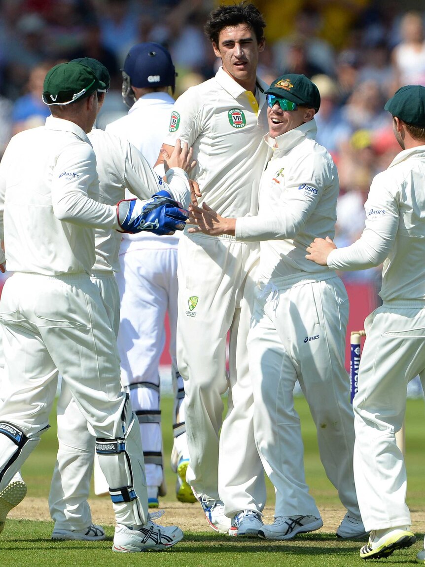 Mitchell Starc celebrates taking the wicket of Joe Root