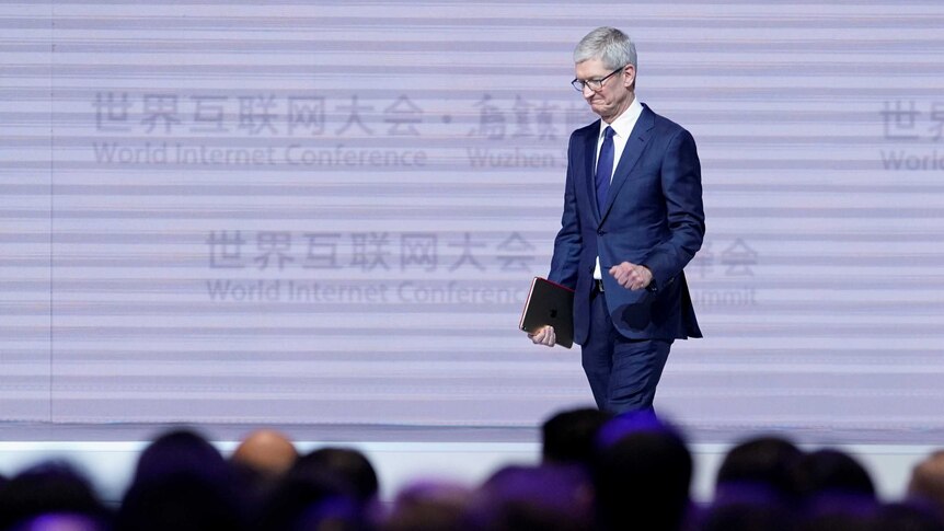 Apple CEO Tim Cook attends the opening ceremony.