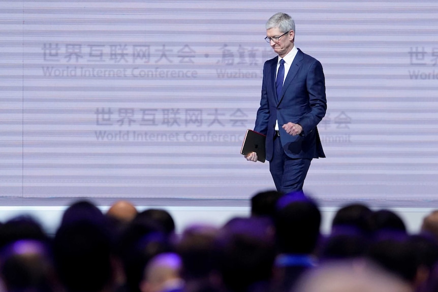 Apple CEO Tim Cook attends the opening ceremony.