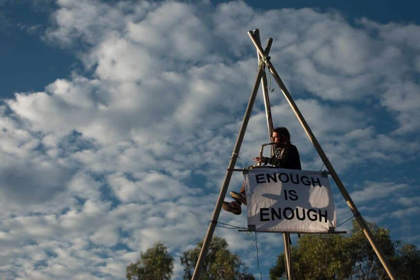 An activist blockades the construction of the Maules Creek coal mine project in north-west NSW.