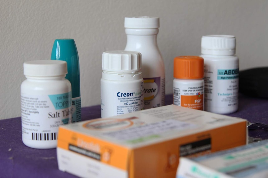 A group of pill canisters on a bench.