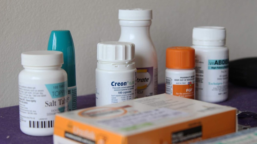 A group of pill canisters on a bench.