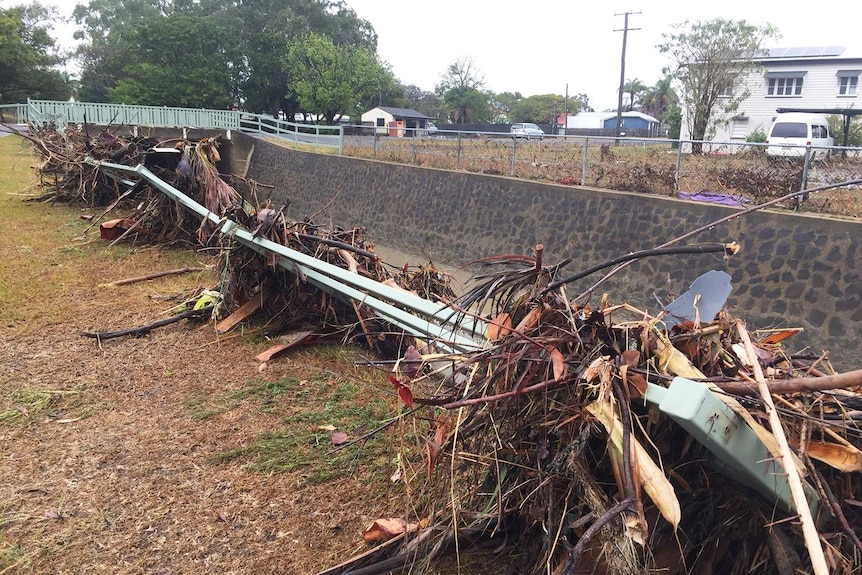 Debris in a guard rail in a street in Bundaberg on October 3, 2017 after 340mm of rain in 24 hours.
