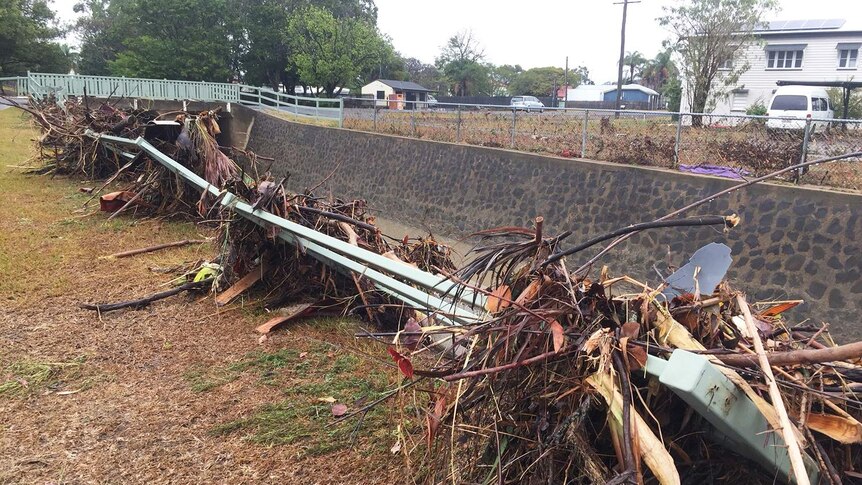 Debris in a guard rail in a street in Bundaberg on October 3, 2017 after 340mm of rain in 24 hours.