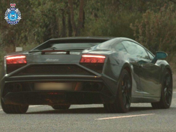 A dark-coloured supercar – a Lamborghini Gallardo – seen from behind.