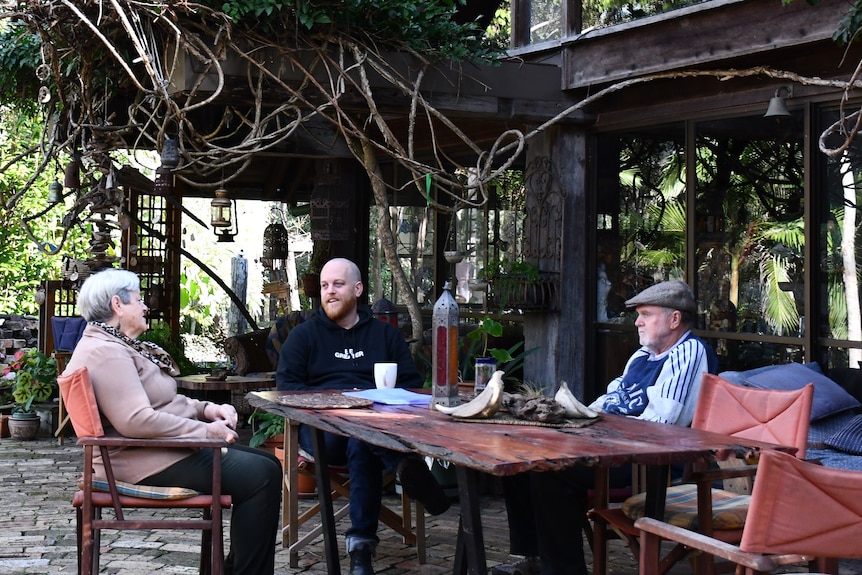 Harriet and Ken Aiken sit with their son Anthony at the main house