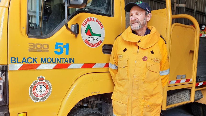 Black Mountain rural fire brigade first officer Harry Kirk in front of a fire tanker