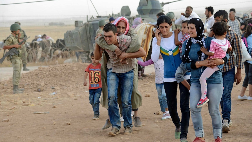 About 70,000 Syrian Kurds have fled into Turkey since Friday.
