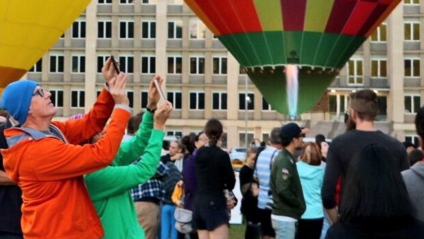 Tourists using smart phones to take photos at Canberra Balloon Spectacular.