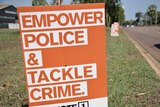 an orange sign saying 'empower police and tackle crime'