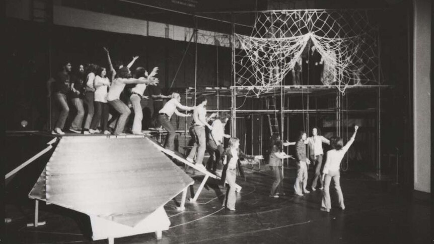 A black and white image of rehearsals on a stage.