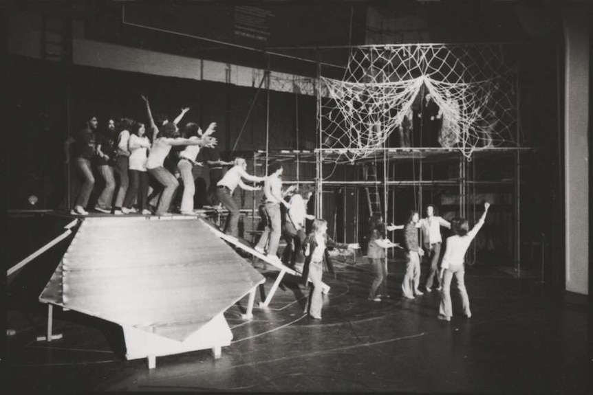 A black and white image of rehearsals on a stage.