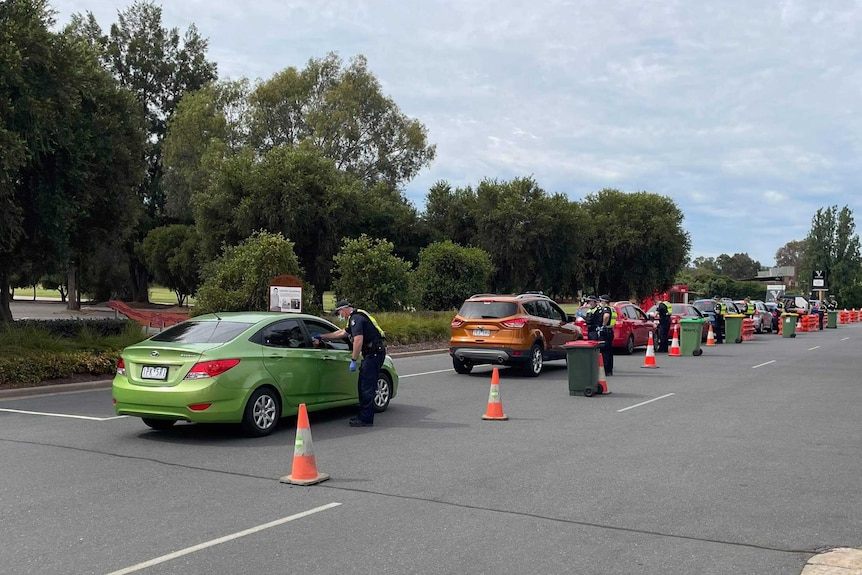 A line of cars at a border checkpoint in Victoria