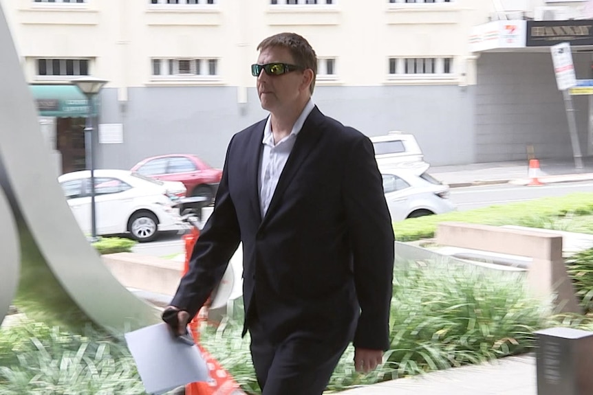 Allan McNevin walking into Brisbane Magistrates Court
