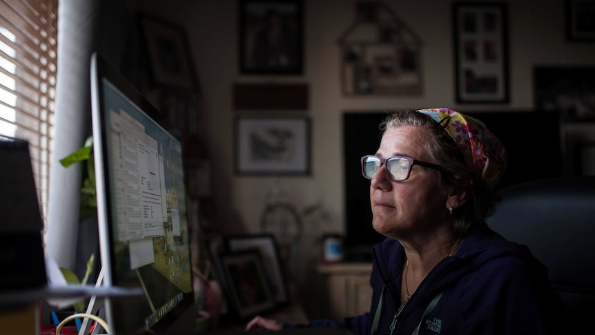 Nadine Tomlinson studies emails about her daughter Chloe at her home in Kambalda, WA.
