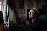 Nadine Tomlinson studies emails about her daughter Chloe at her home in Kambalda, WA.