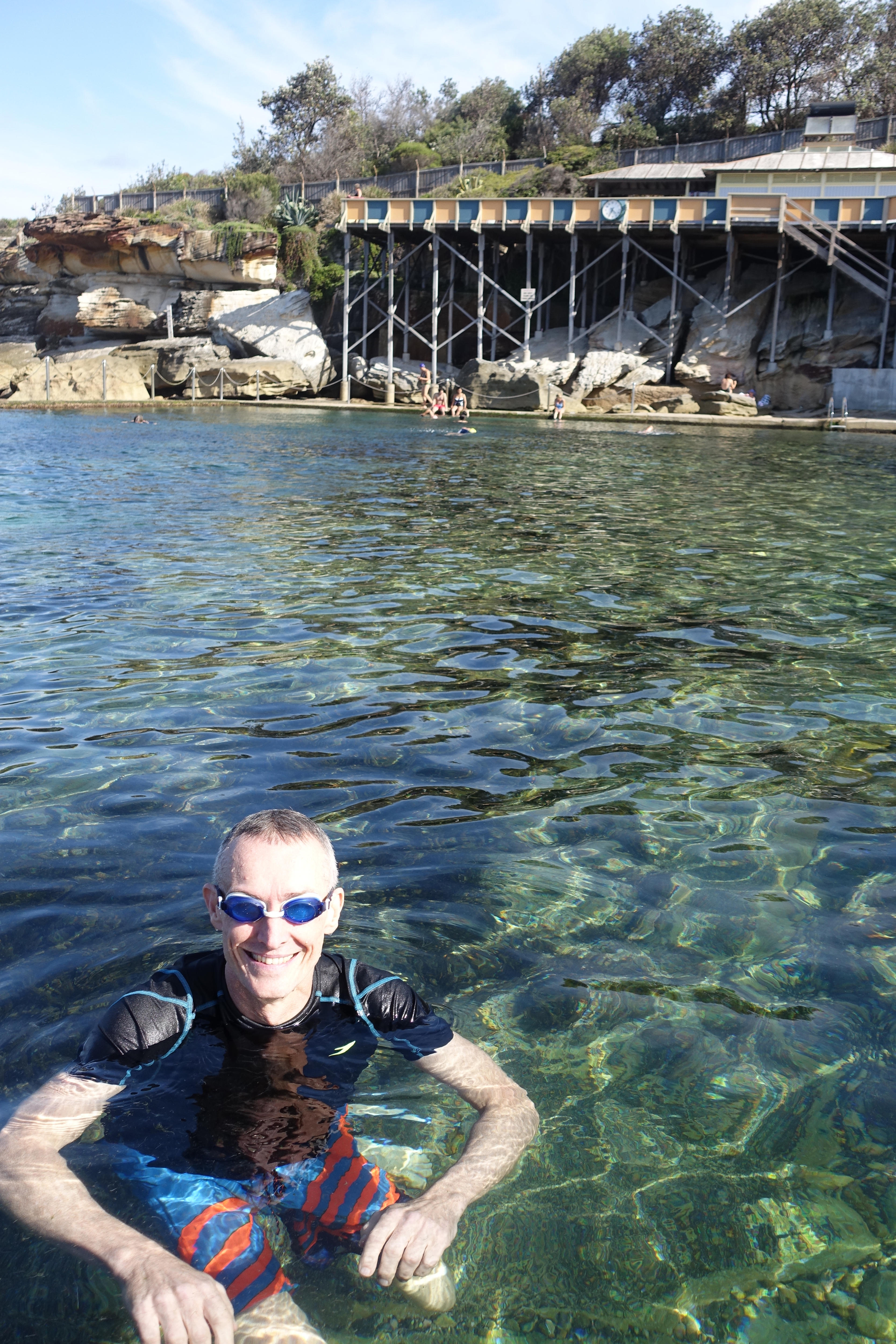 A man in the water with goggles on.