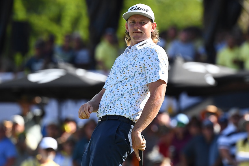 An Australian male golfer reacts after a shot at the Australian PGA Championship.