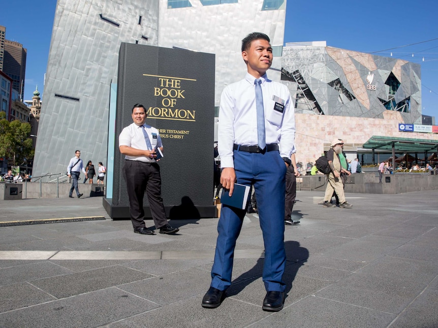 A missionary tries to talk to passers-by about his faith