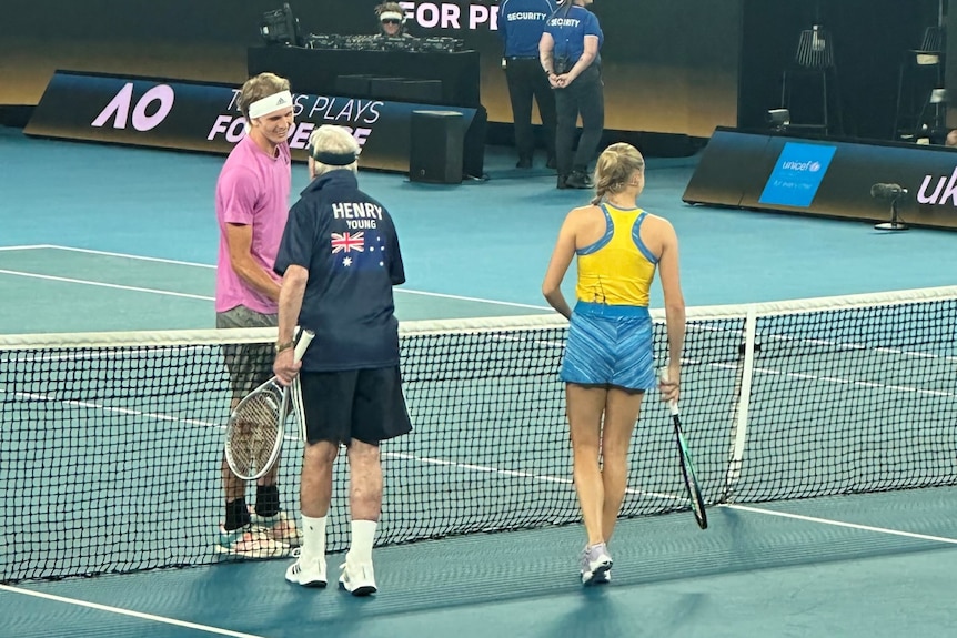 Three tennis players at Australian Open with two chatting