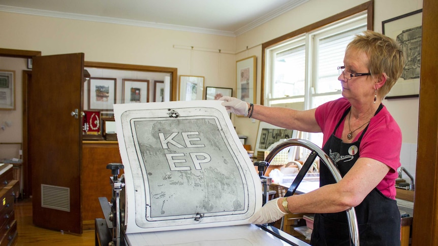 Jenny Peterson looks at her print in her Boolarra studio