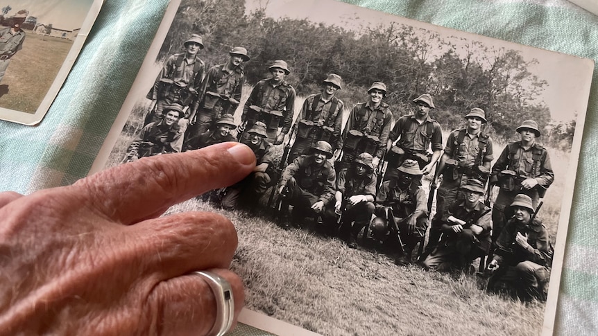 Someone points to an old photograph 