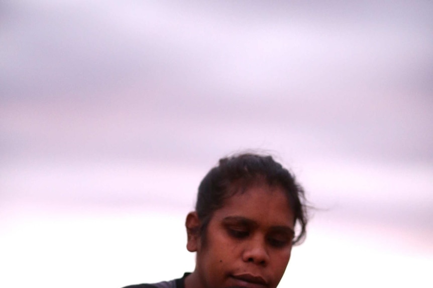 An Aboriginal mother hugs her son