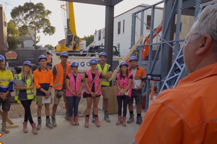 A group of people wearing hard hats and safety vests on a construction site