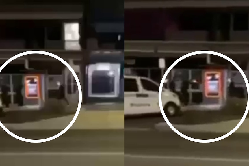 Mobile footage of two police officers holding their guns aimed at a man across a street.