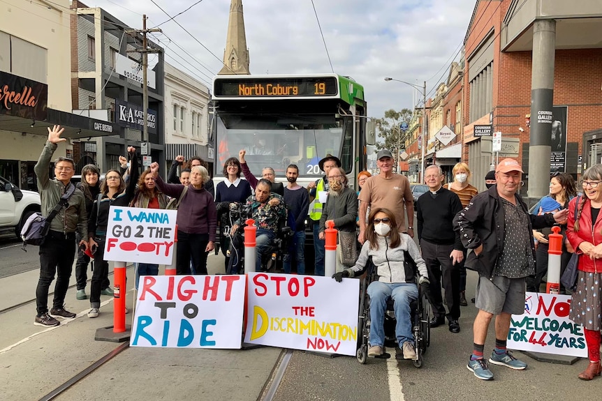 A group of people protesting outside a tram