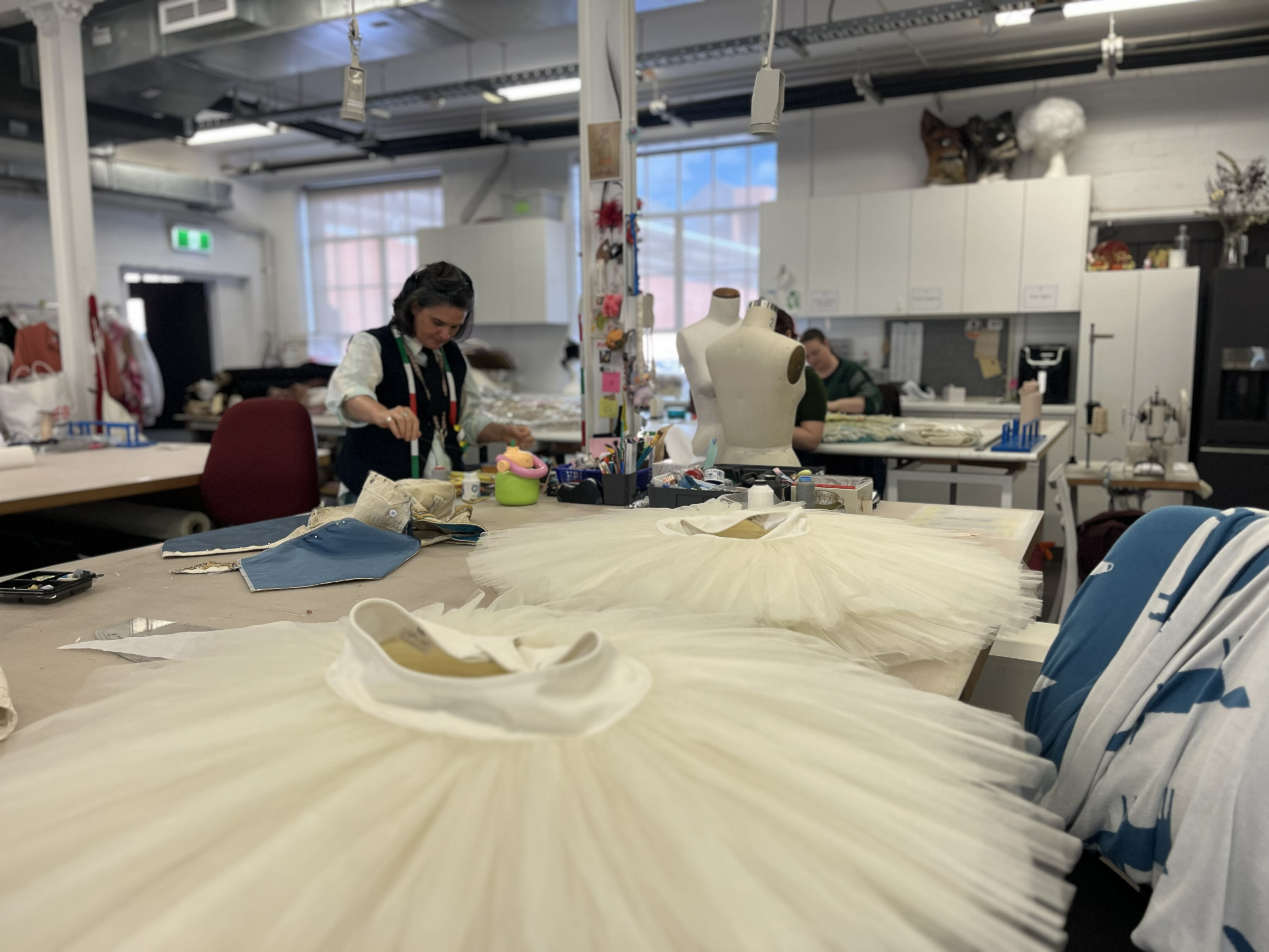 Students stitching in a costume workshop