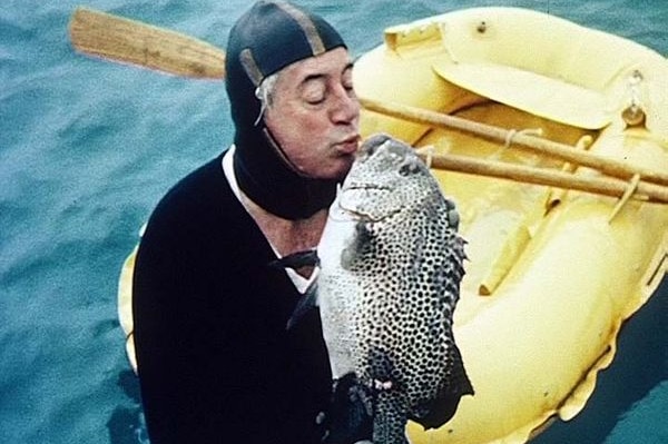 Former prime minister Harold Holt kisses a fish while holidaying in north Queensland