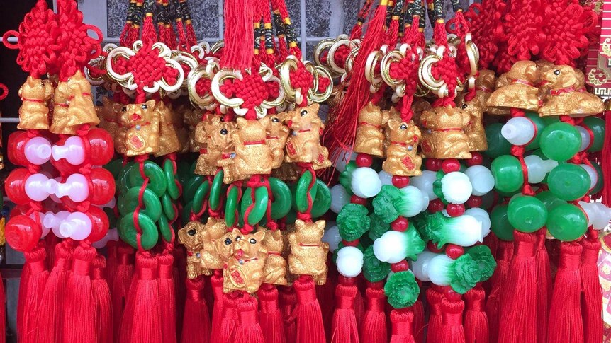 Decorations show small dogs with green and red beads and red tassels.