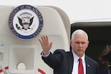 US Vice-President Mike Pence waves with his right hand as he disembarks his aircraft in South Korea, April 18, 2017.