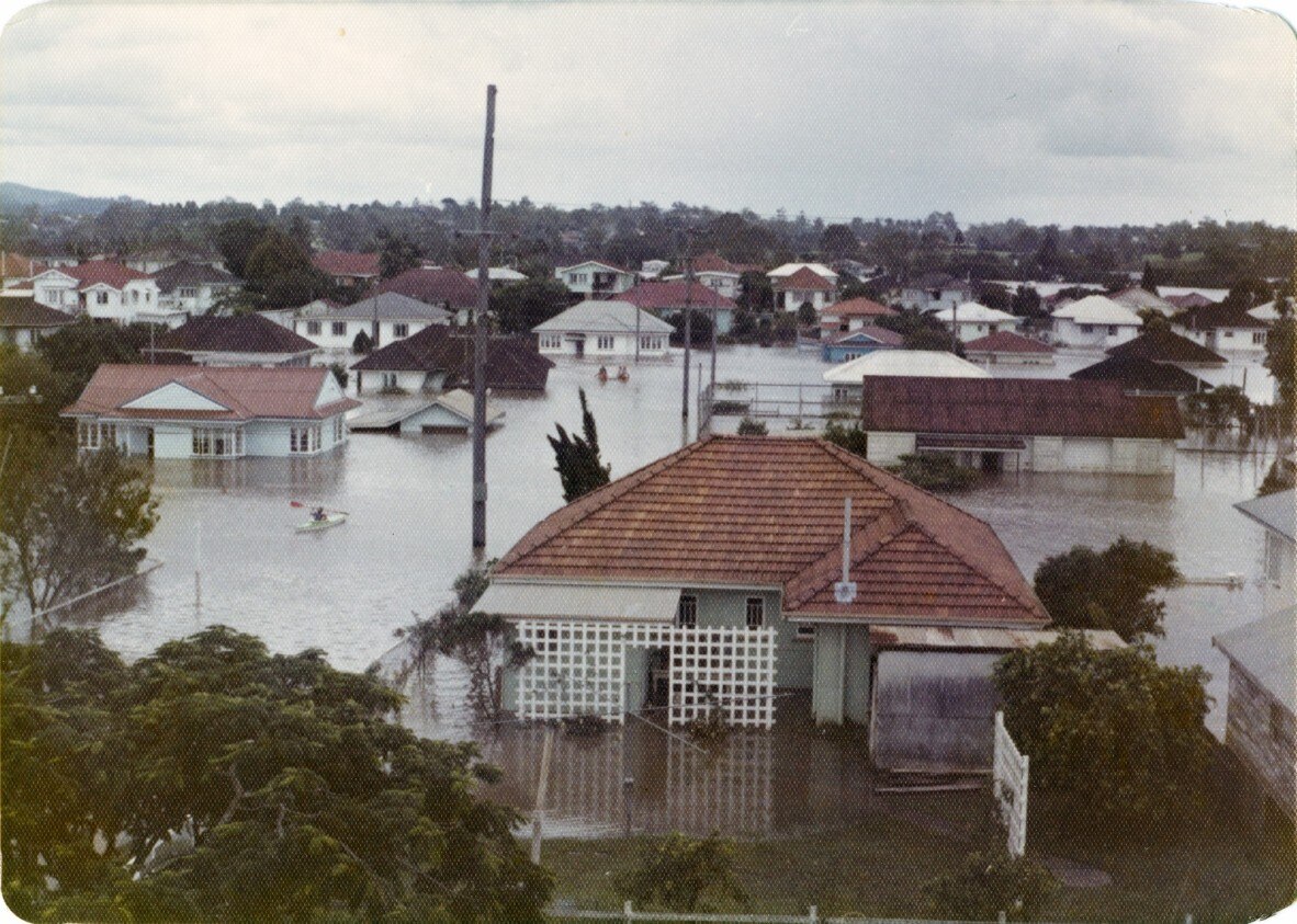A neighbourhood of houses are half-submerged in floodwater during the 1974 Brisbane floods.