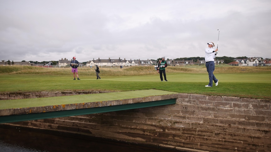 Nelly Korda completes an iron shot from just short of a bridge and creek on the 17th hole at Carnoustie