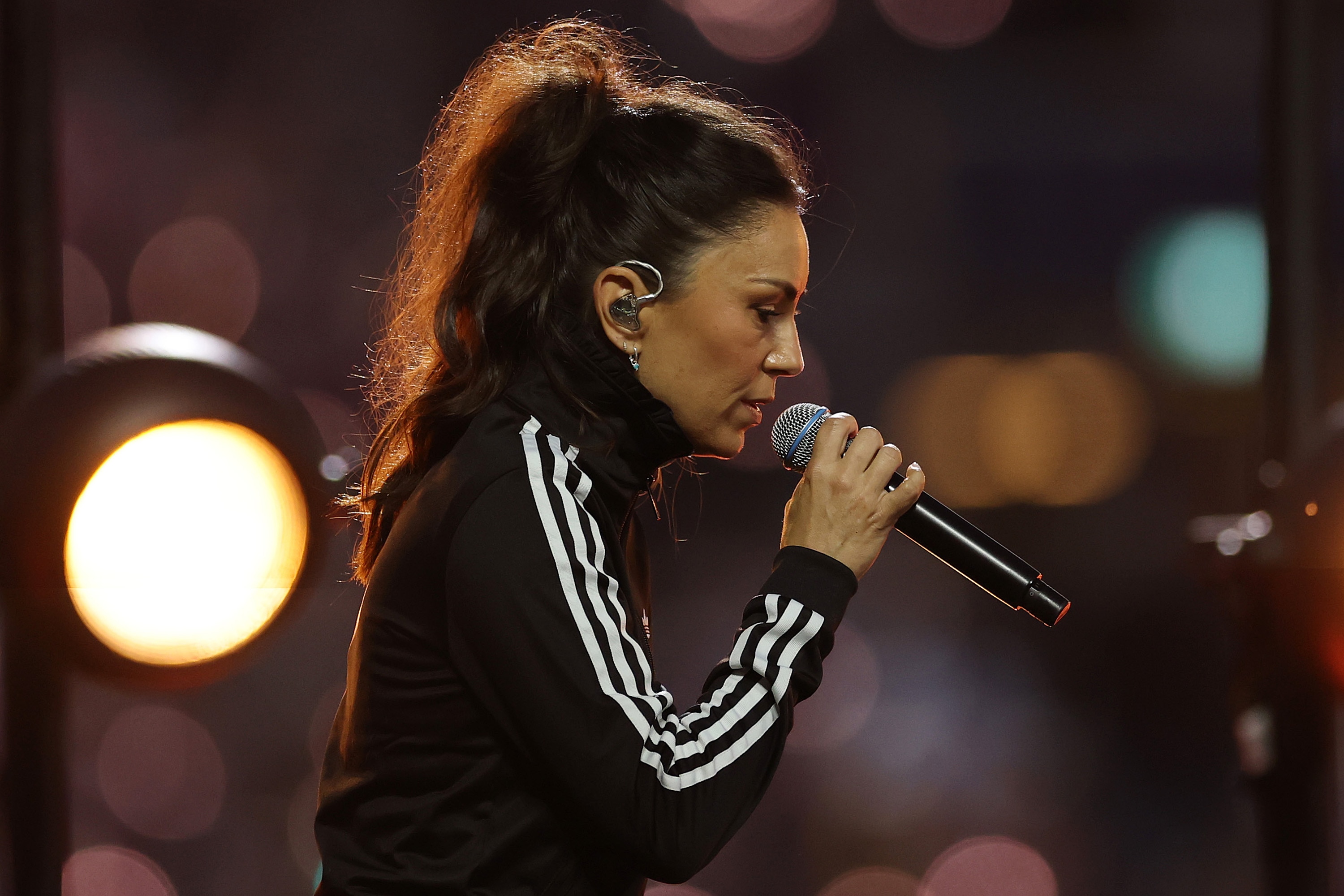 Amy Shark singing in an outdoor stadium