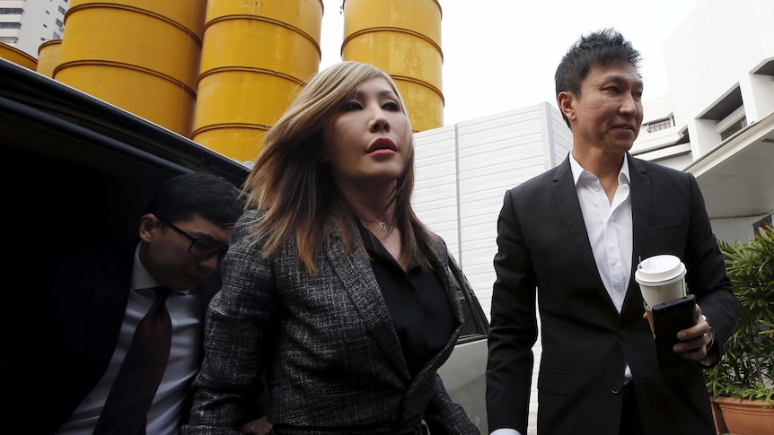 City Harvest Church founder Kong Hee (R) and his wife Sun Ho arrive at the State Courts in Singapore