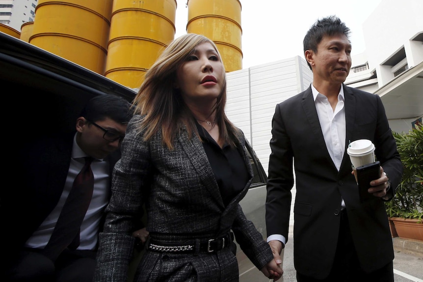 City Harvest Church founder Kong Hee (R) and his wife Sun Ho arrive at the State Courts in Singapore