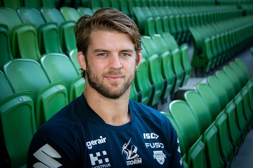 Melbourne Storm veteran Christian Welch sits in a stadium seat.