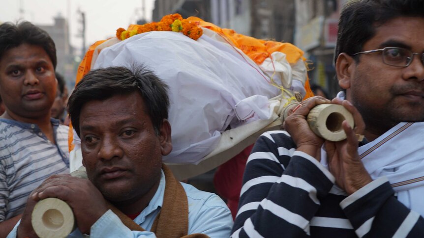 The brothers of rail crash victim Narendra Sinhu carry his body to the Ganges for cremation.
