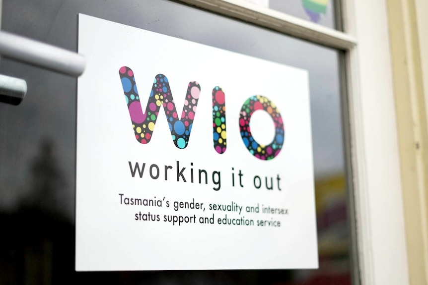 A colourful sign on a door reads Working It Out