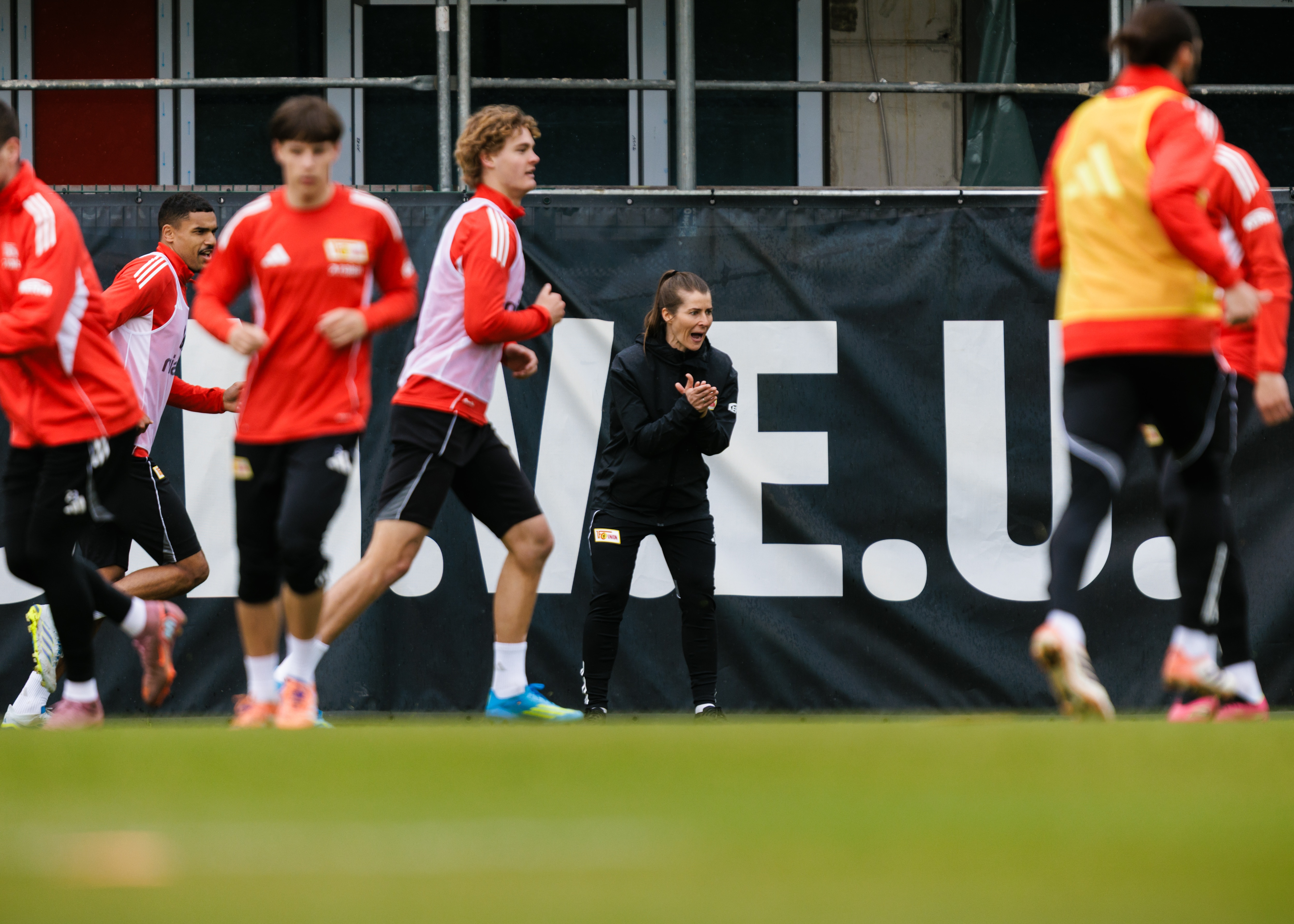 Marie Louise Eta claps as players train in front of her
