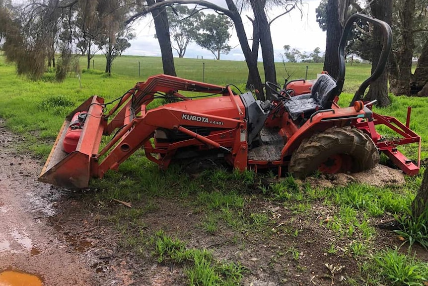 a bogged tractor in a field