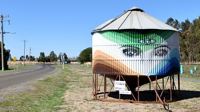 A painted grain silo on the side of the road as you enter a small Victorian town of Dookie