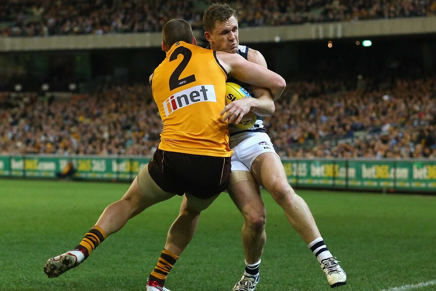 Jarryd Roughead of the Hawks tackles Joel Selwood of the Cats in the qualifying final at the MCG.