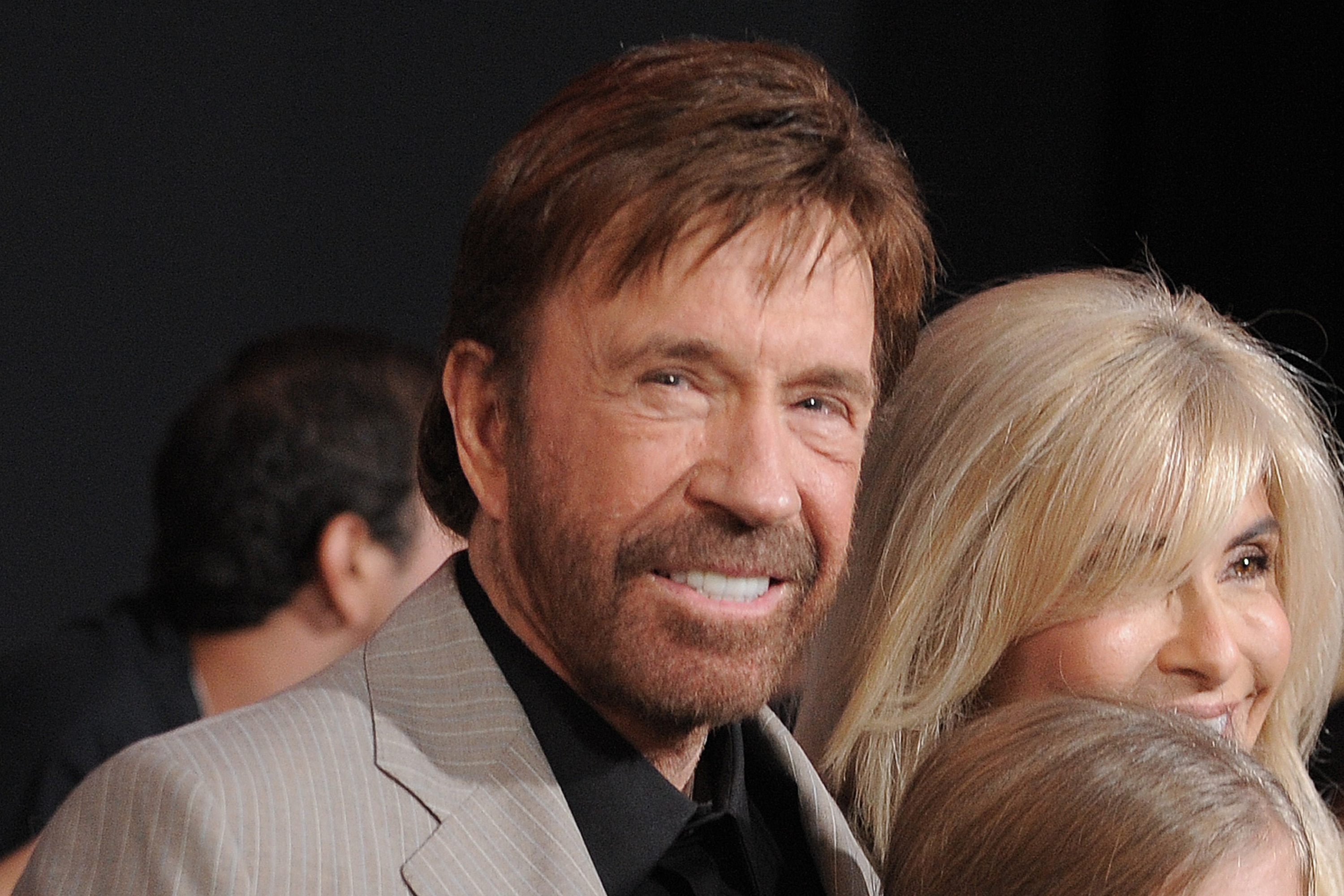 Chuck Norris smiles during a film premiere.