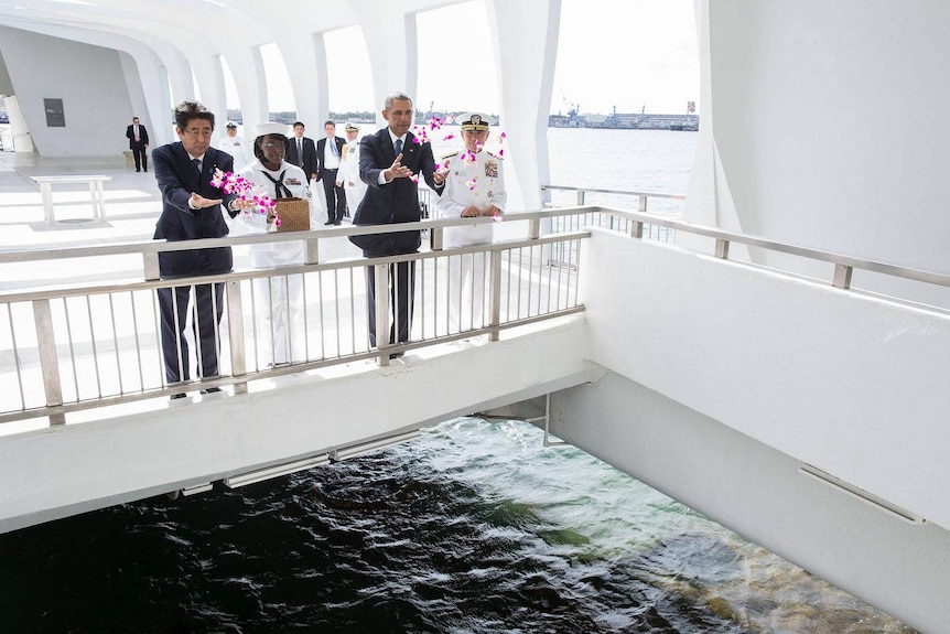 President Obama and Shinzo Abe toss petals into the wishing well